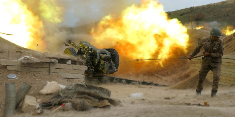 An ethnic Armenian soldier fires an artillery piece during a military conflict over the breakaway region of Nagorno-Karabakh, in this handout picture released October 5, 2020. Picture released October 5, 2020. Press office of Armenian Defense Ministry/PAN Photo/Handout via REUTERS ATTENTION EDITORS - THIS IMAGE HAS BEEN SUPPLIED BY A THIRD PARTY. MANDATORY CREDIT.