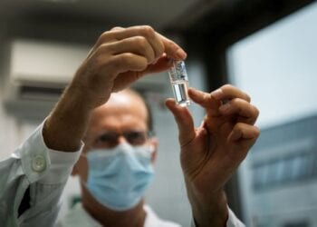 A laboratory assistant holds a tube with Russia's "Sputnik-V" vaccine against the coronavirus disease (COVID-19) at the National Institute of Pharmacy and Nutrition in Budapest, Hungary, November 19, 2020. Matyas Borsos/Hungarian Foreign Ministry/Handout via REUTERS  THIS IMAGE HAS BEEN SUPPLIED BY A THIRD PARTY. NO RESALES. NO ARCHIVES