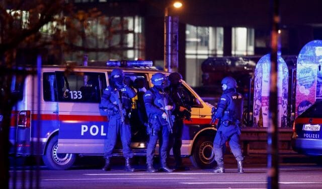 Police officers stand guard on a street after exchanges of gunfire in Vienna, Austria November 3, 2020. REUTERS/Leonhard Foeger