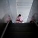 A woman wearing a mask rides on an escalator, almost a year after the start of the coronavirus disease (COVID-19) outbreak, in Wuhan, Hubei province, China December 17, 2020. REUTERS/Aly Song