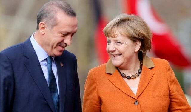 epa03600271 German Chancellor Angela Merkel (R) is greeted with military honors by Prime Minister of Turkey Recep Tayyip Erdogan in Ankara, Turkey, 25 February 2013. German Chancellor Angela Merkel arrived in Turkey 24 February to push forward the country's accession talks with the European Union, even though she remains sceptical about their outcome. She was set to propose on 25 February to Prime Minister Recep Tayyip Erdogan in Ankara that Turkey start negotiations in the areas of economic or regional policies with the EU.  EPA/KAY NIETFELD