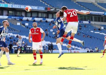 Arsenal's Shkodran Mustafi heads at goal under a challenge from Brighton & Hove Albion's Solly March as play resumes behind closed doors following the outbreak of the coronavirus disease (COVID-19) during the Premier League match between Brighton & Hove Albion and Arsenal, at The American Express Community Stadium, in Brighton, Britain, on June 20, 2020. Photo: Gareth Fuller/Pool via Reuters