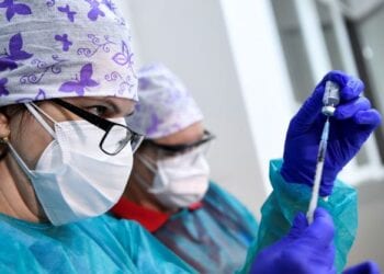 A healthcare worker fills a syringe with the Pfizer-BioNTech COVID-19 vaccine at the University Hospital, as the coronavirus disease (COVID-19) outbreak continues, in Nitra, Slovakia, December 26, 2020. REUTERS/Radovan Stoklasa