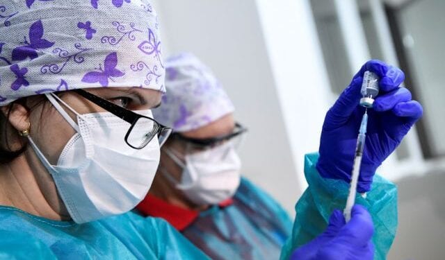 A healthcare worker fills a syringe with the Pfizer-BioNTech COVID-19 vaccine at the University Hospital, as the coronavirus disease (COVID-19) outbreak continues, in Nitra, Slovakia, December 26, 2020. REUTERS/Radovan Stoklasa