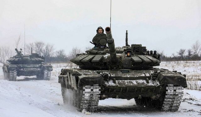 Russian servicemen drive tanks during military exercises in the Leningrad Region, Russia, in this handout picture released February 14, 2022. Russian Defence Ministry/Handout via REUTERS ATTENTION EDITORS - THIS IMAGE HAS BEEN SUPPLIED BY A THIRD PARTY. MANDATORY CREDIT. NO RESALES. NO ARCHIVES.